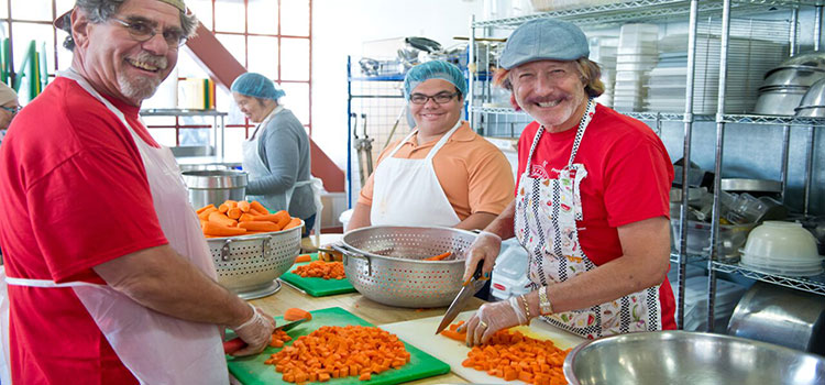 Volunteers in San Francisco chopping carrots